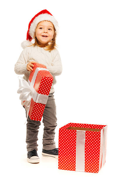Surprised little girl opening her present