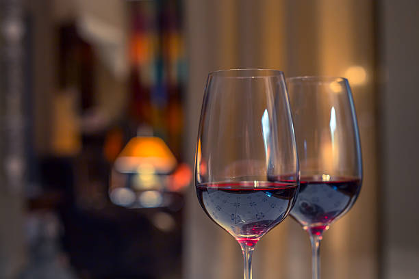 Pair of red wine glasses, closeup shot Closeup shot of two glasses of red wine pair stock pictures, royalty-free photos & images