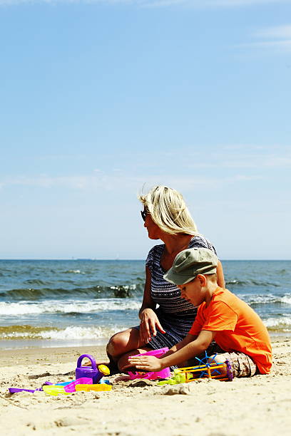 istock Son and mother playing toys on beach 506362209