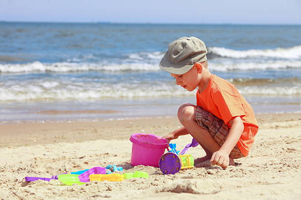 istock boy playing toys on beach 506362839