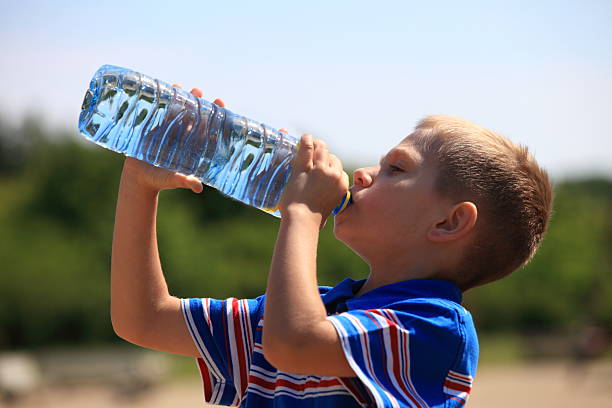 istock Child drinking pure water in nature 506363183