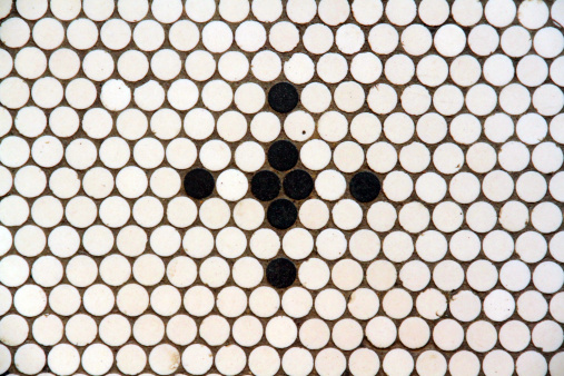 A cross pattern in a tile floor. 