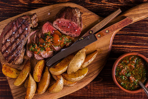 istock Grilled steak with potato wedges, salsa and spices. 506387558