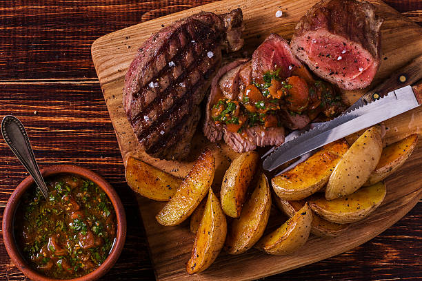 istock Grilled steak with potato wedges, salsa and spices. 506387832