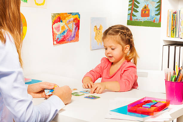 istock Little girl taking cards from table in the class 506387862