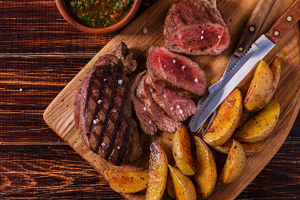 istock Grilled steak with potato wedges, salsa and spices. 506388032