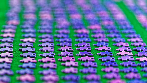 istock purple puzzle pieces sorted on a green table cloth 506389548