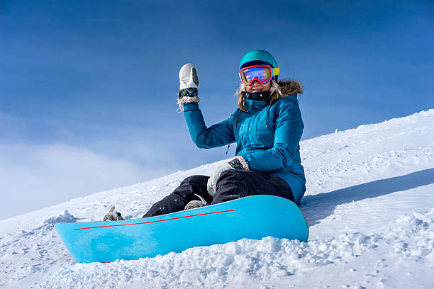 istock Young woman snowboarder in mountains 506389766