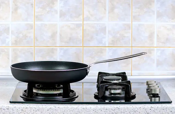 the frying pan taken closeup on a gas stove