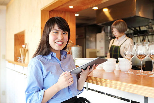 istock Young female proprietor with a handheld terminal2 506391296