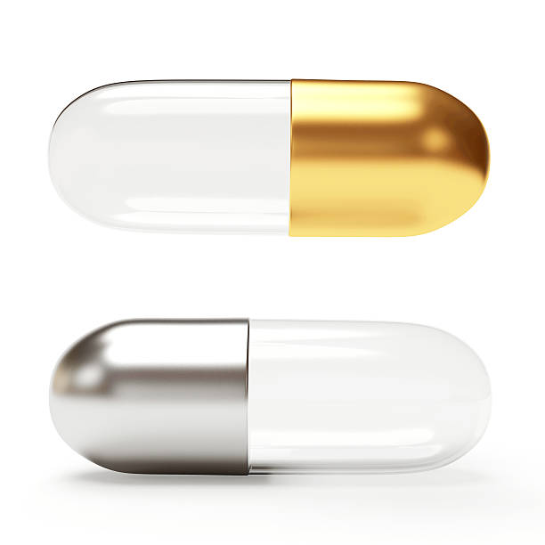 istock Golden and silver transparent medical capsules 506396504