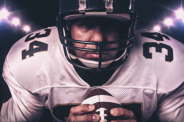 istock player gripping football 506397335