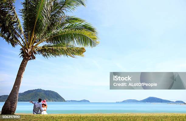 Couple Sitting Near The Sea Stock Photo - Download Image Now - Adult, Adults Only, Back