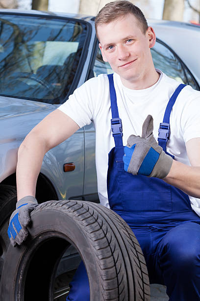 istock Mechanic with a tire 506398011