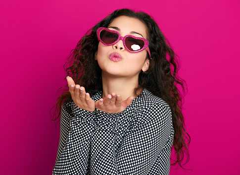 beautiful girl glamour portrait on pink make flying kiss