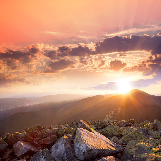 Sunset in the mountains landscape. Dramatic sky,  colorful stones and sunbeams. Carpathians, Ukraine, Europe