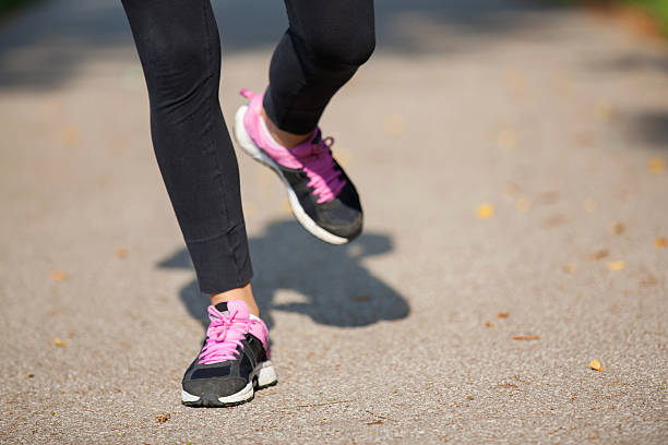 istock Runner feet running on road closeup on shoe 506399233