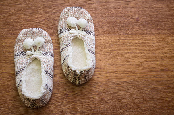 istock Knitted slippers with pompoms 506399648