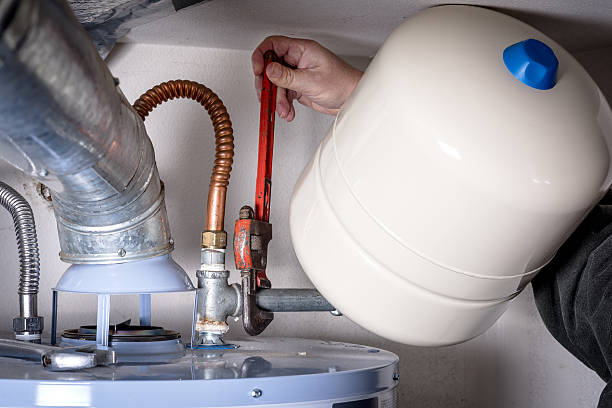 istock Plumbers does maintenance on a hot water heater 506400058