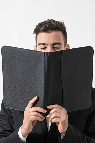 istock Man in suit reading restaurant menu or  business contract. 506400624