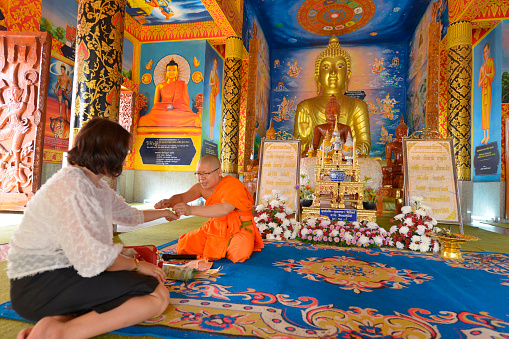Bangkok, Thailand - August 26, 2023: people praying at Wihan Phra Mongkhon Bophit temple. Ayutthaya. Phra Nakhon Si Ayutthaya province. Thailand.