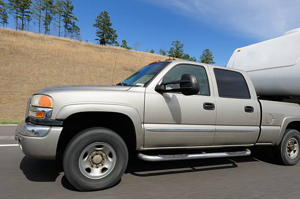 istock Pickup truck towing trailer on highway 506401806
