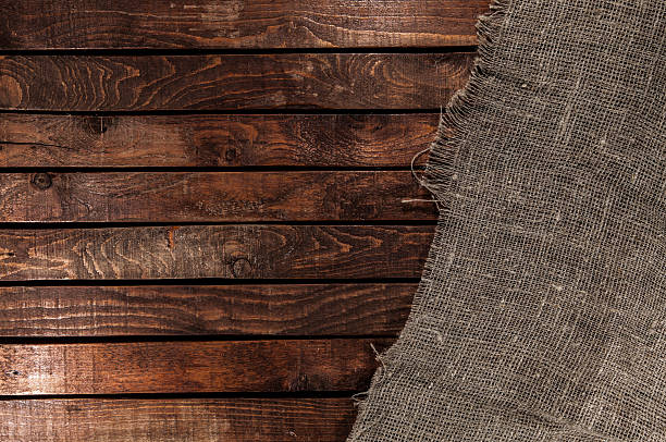 istock Burlap texture on wooden table background 506402130