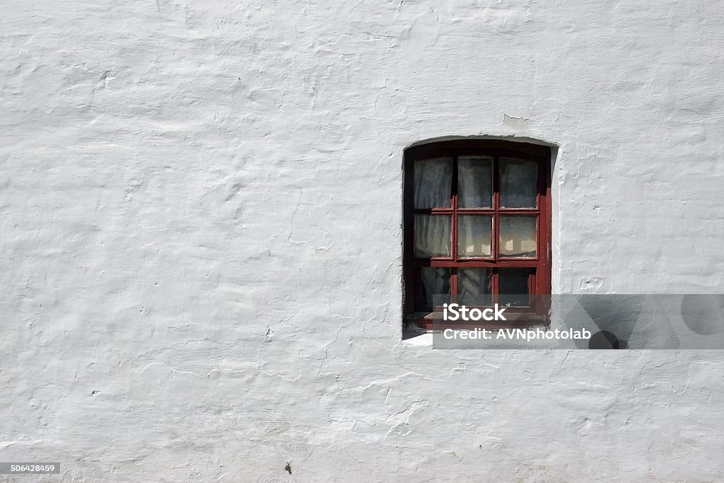 White old brick wall with window White old brick wall with window. Background, with space for text or image. Ancient Stock Photo