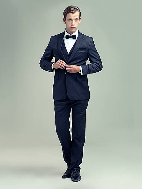 You clean up nice A full length studio portrait of a dapper young man wearing a vintage suit and bow tie tuxedo stock pictures, royalty-free photos & images