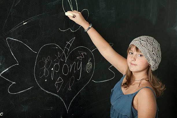 istock Schoolgirl near school board 506430626