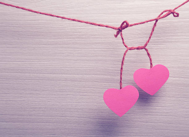 istock Two paper hearts hanging on a rope 506431058