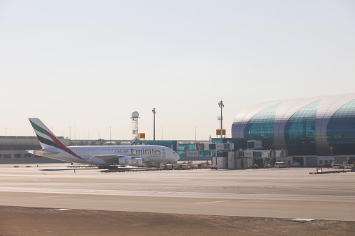 Dubai, United Arab Emirates - December 10, 2015: An airbus A 380 of Emirates airline waiting in front of Dubai international airport. Dubai has one of the most frequented airports in the world. Its Airline Emirates connects almost every destination in the world.