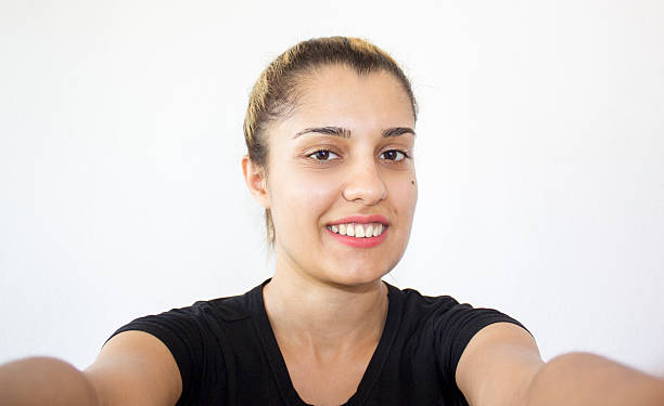 istock Young woman taking a selfie against colored background 506431410