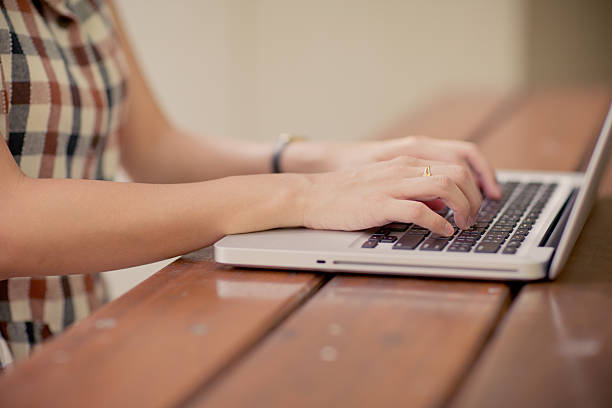 istock Woman using laptop indoor.close-up hand 506431603