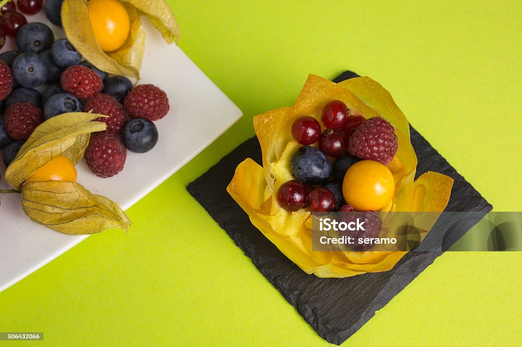 mini cheesecake with filo pastry and berries mini cheesecakes with filo pastry and different berries on top Baked Stock Photo