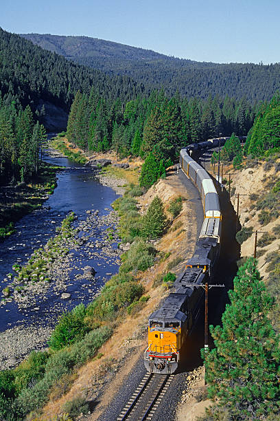 istock Freight (cargo) train winding along a scenic river valley 506432627