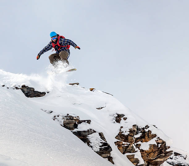 istock Snowboarder jumping in mountains 506433854