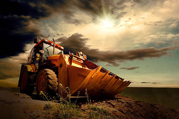 trattore giallo su sfondo di cielo - earth mover working field dirt foto e immagini stock