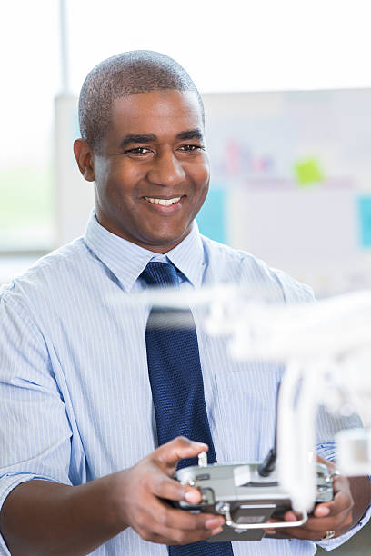 istock Mid adult African American man controls drone with controller 506434338