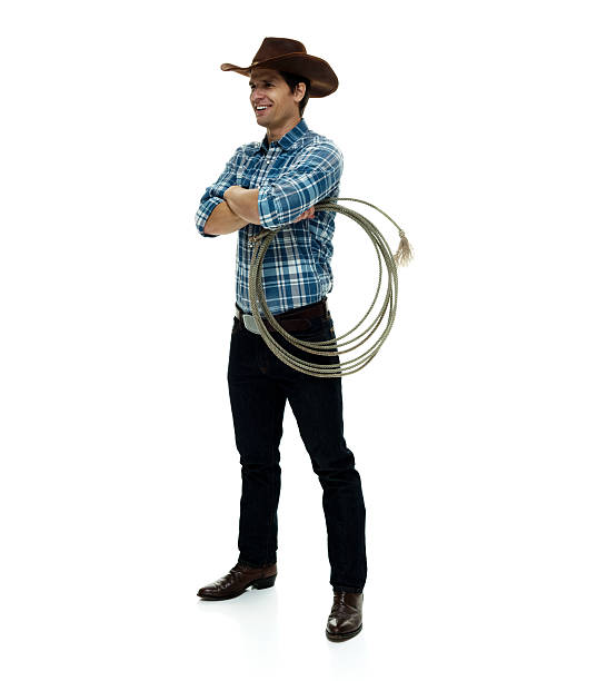 istock Smiling cowboy standing with arms crossed 506435730