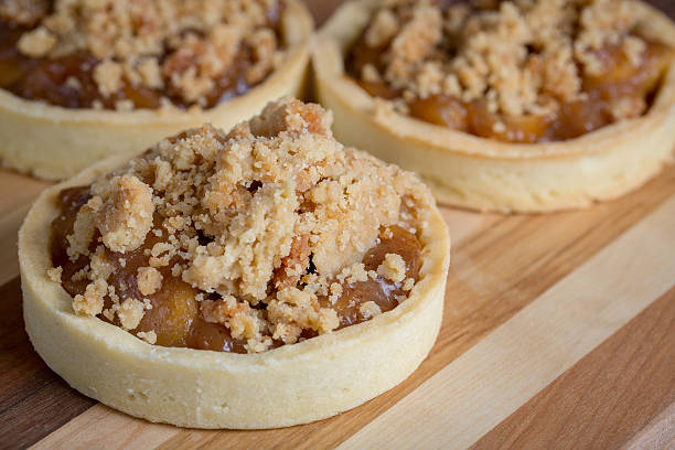istock Small Apple Tart Desserts on wood cutting board 506436368