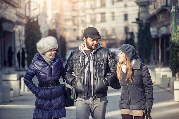 istock Friends Chatting and Walking Through a City Centre 506436386