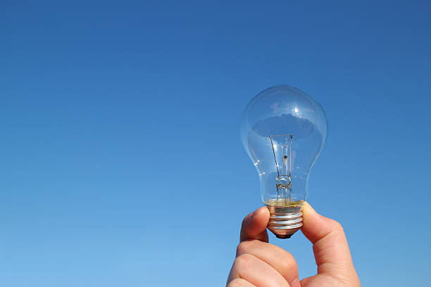 istock light bulb and the hand in the blue sky 506436578