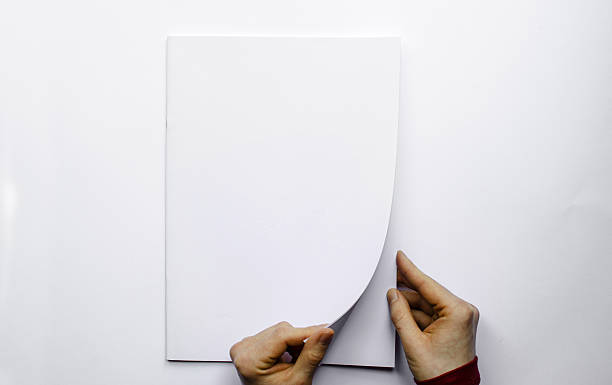 istock Opening a blank brochure photographed from above 506436734