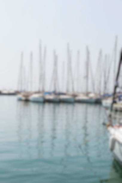 Defocused Summer Background with Yachts Yachts in harbour. Defocused summer background. truism stock pictures, royalty-free photos & images