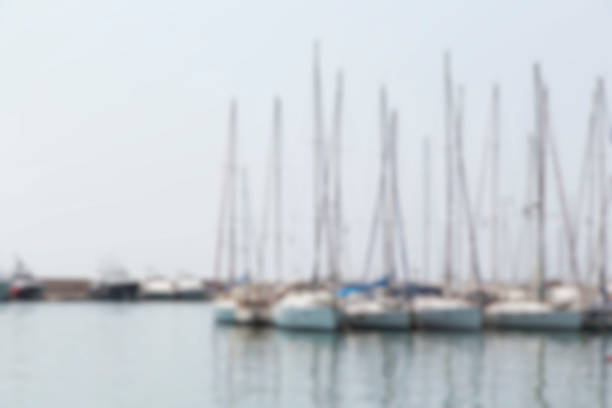 Defocused Summer Background with Yachts Yachts in harbour. Defocused summer background. truism stock pictures, royalty-free photos & images