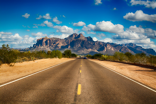 A long remote road leading to the base of famous Superstition Mountain in Arizona shows the beauty of this desert landscape.