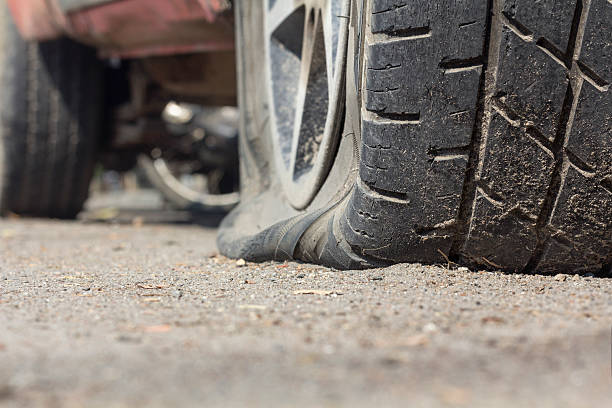 istock Car flat tire on road 506441326