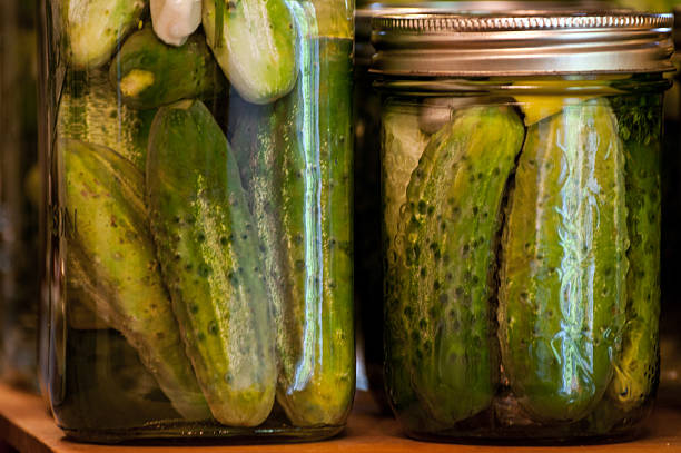 Dill Pickles Quart and Pint Two bottles of Dill Pickles in a Quart and Pint bottle dill pickle stock pictures, royalty-free photos & images