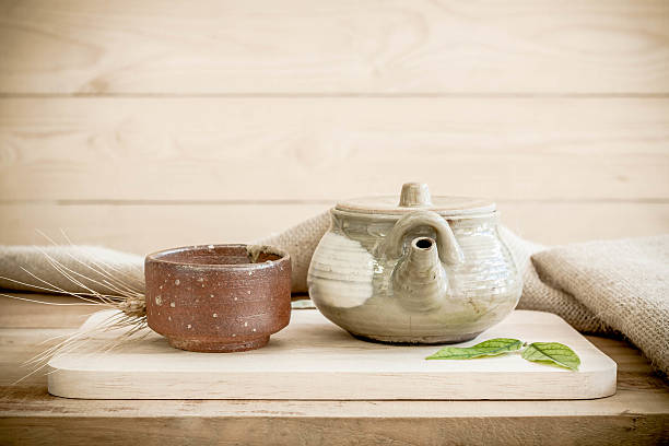 istock Teapot on wooden and sackcloth background. 506442460